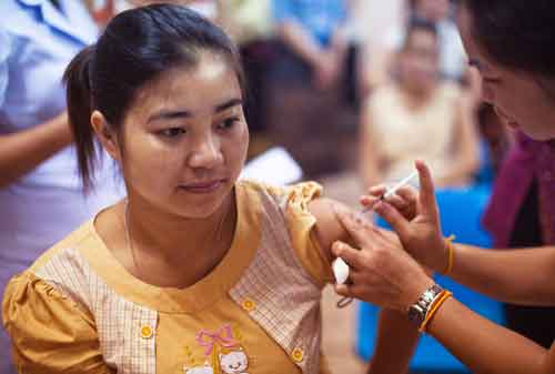 Image of young adult getting a vaccination,